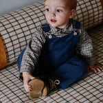 Baby boy wearing Lalaby Ole overalls for babies and kids in whale blue cotton baby cord