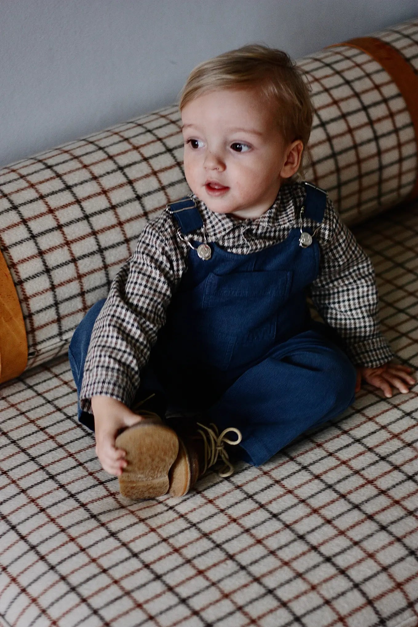 Baby boy wearing Lalaby Ole overalls for babies and kids in whale blue cotton baby cord