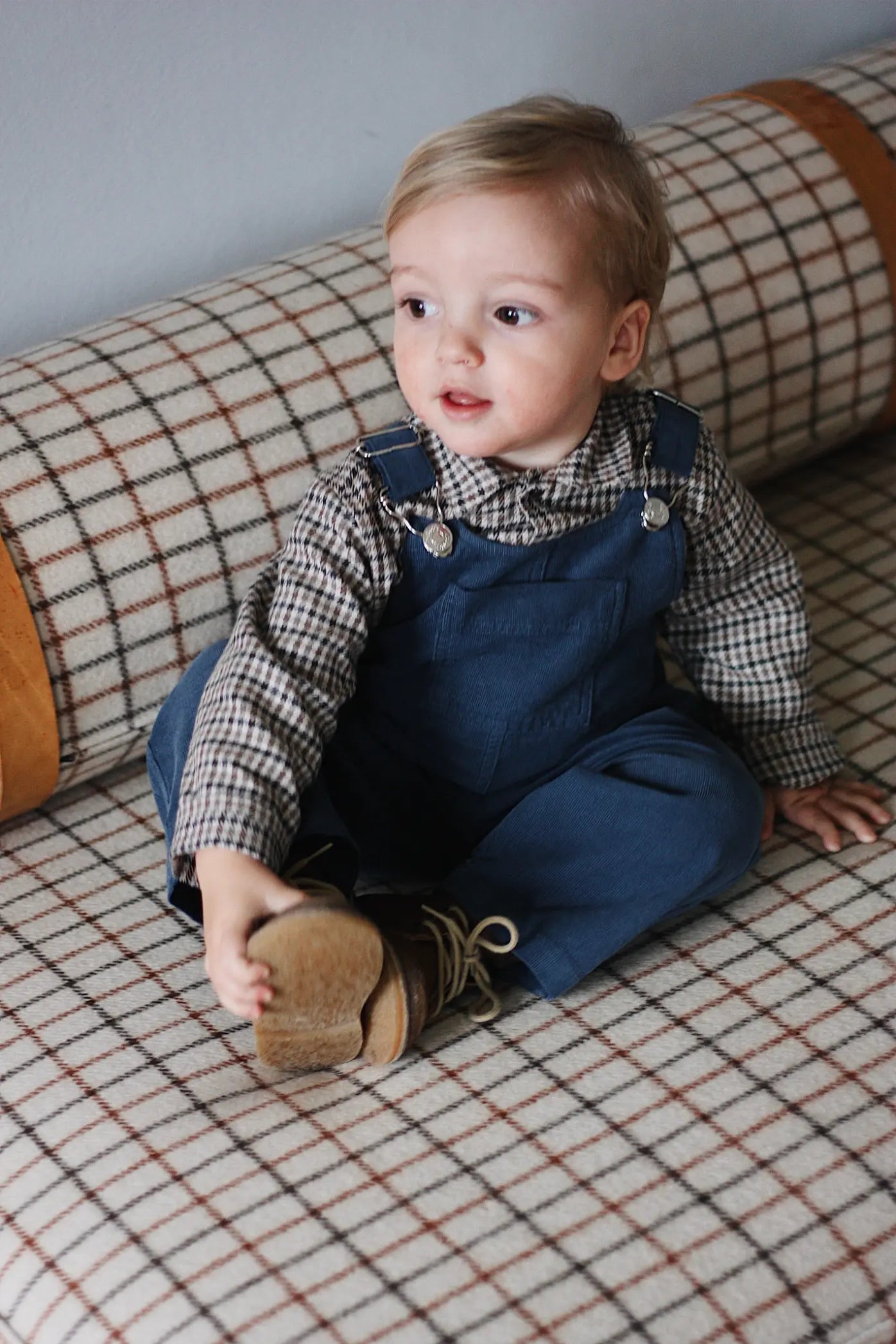 Baby boy wearing Lalaby Ole overalls for babies and kids in whale blue cotton baby corduroy