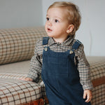 Baby boy wearing Lalaby Ole overalls for babies and kids in whale blue cotton baby corduroy