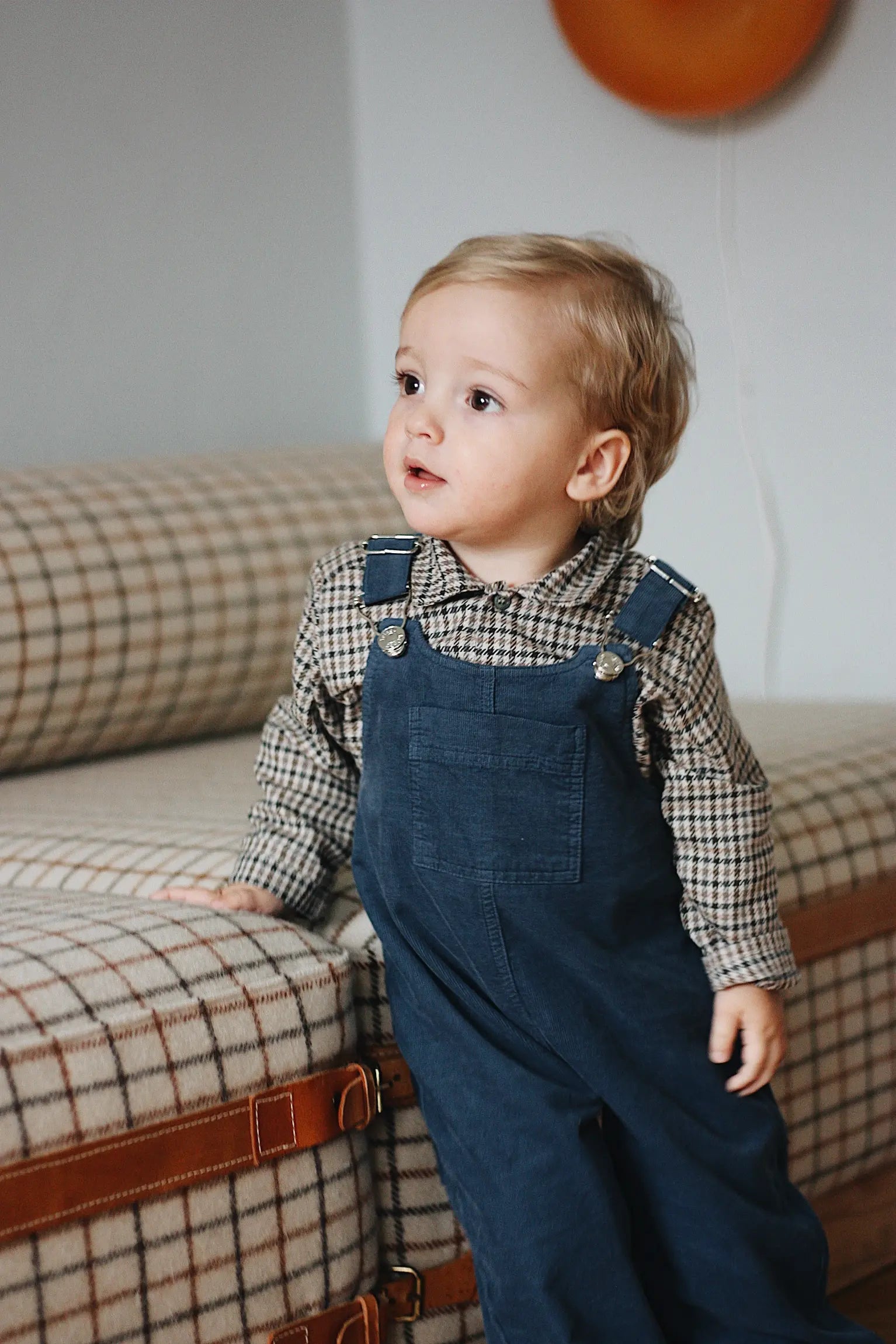 Baby boy wearing Lalaby Ole overalls for babies and kids in whale blue cotton baby corduroy