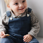 Baby boy wearing Lalaby Ole overalls for babies and kids in whale blue cotton baby corduroy