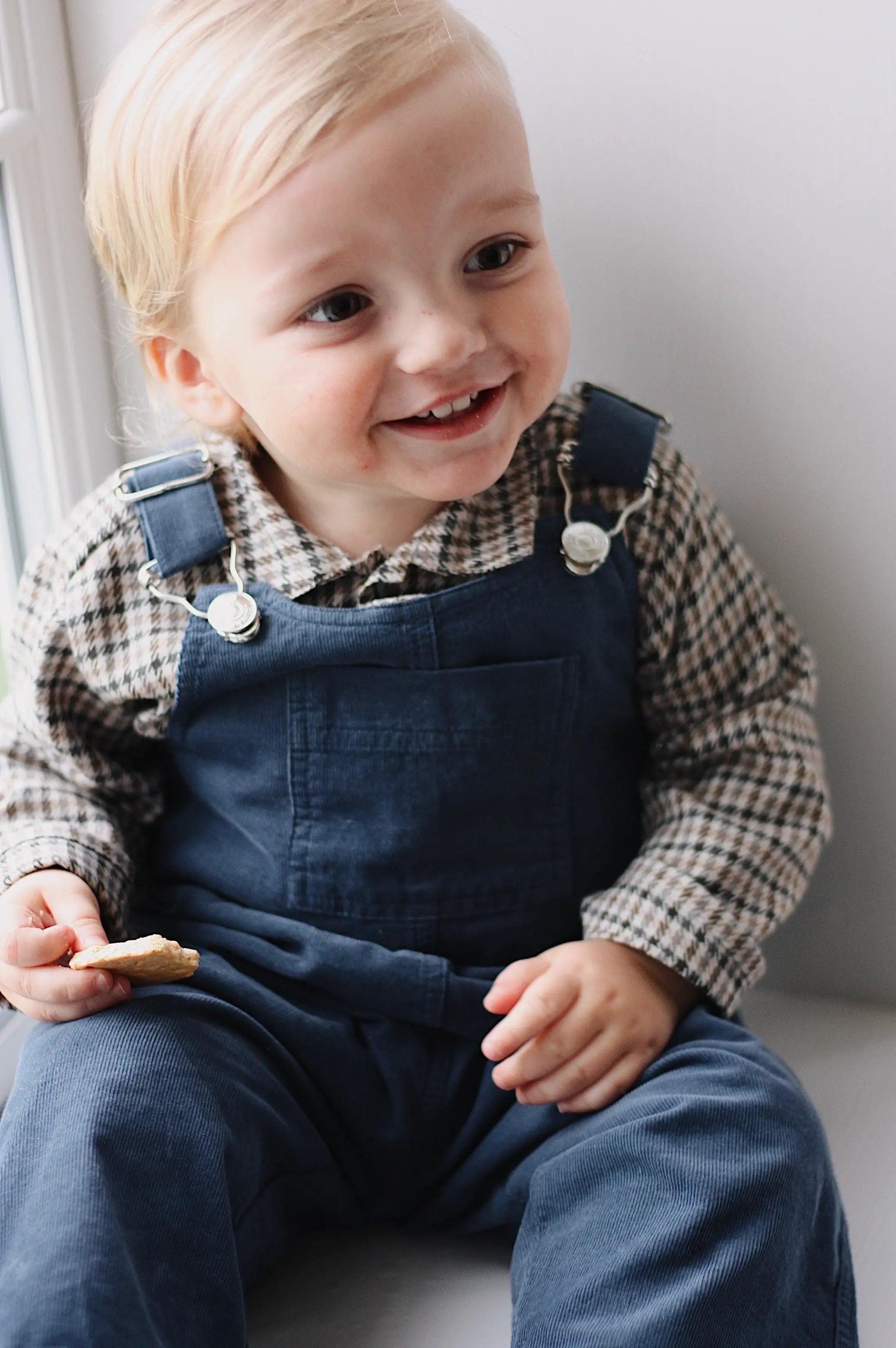 Baby boy wearing Lalaby Ole overalls for babies and kids in whale blue cotton baby corduroy
