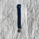 Lalaby pacifier clip in whale blue cotton baby cord with a metal clip for attachment  