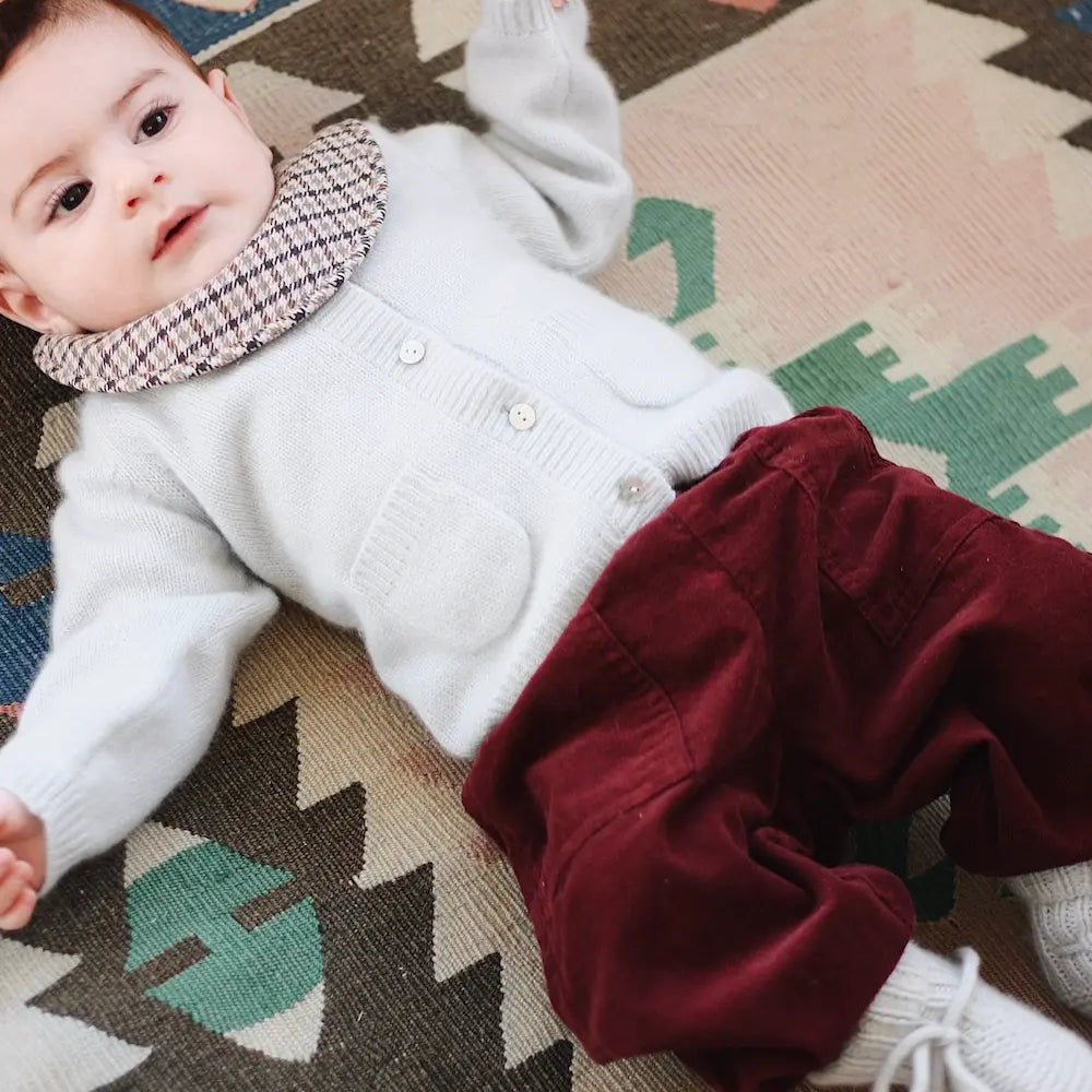 Baby boy wearing Lalaby Panda pants in ruby red cotton baby corduroy