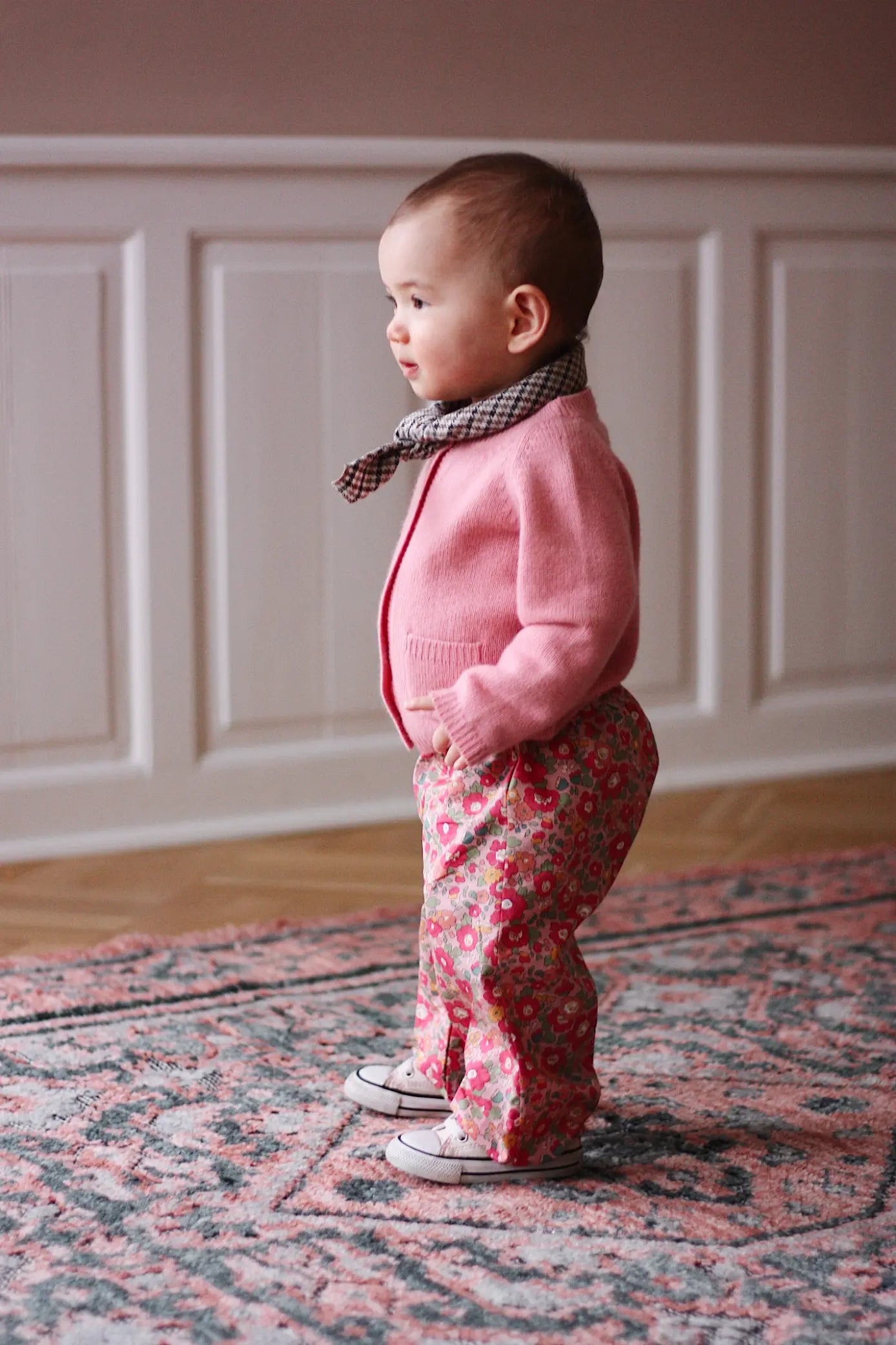 Baby girl wearing Lalaby Pixi baby pants in Berry besty pink liberty organic cotton