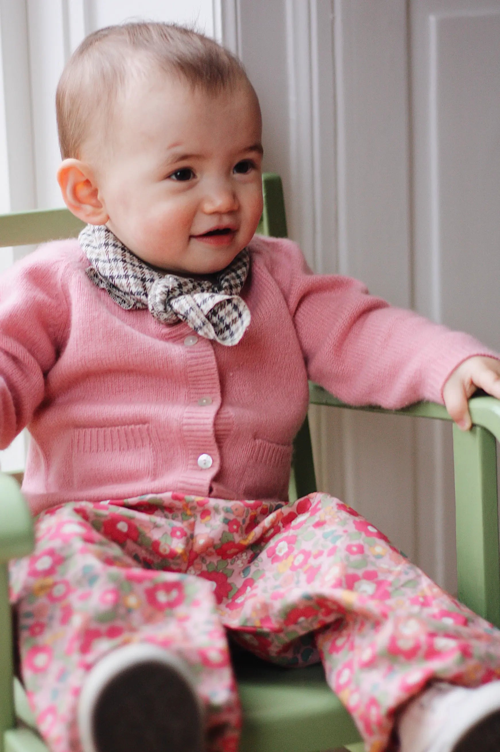 Baby girl wearing Lalaby Pixi baby pants in Berry besty pink liberty organic cotton
