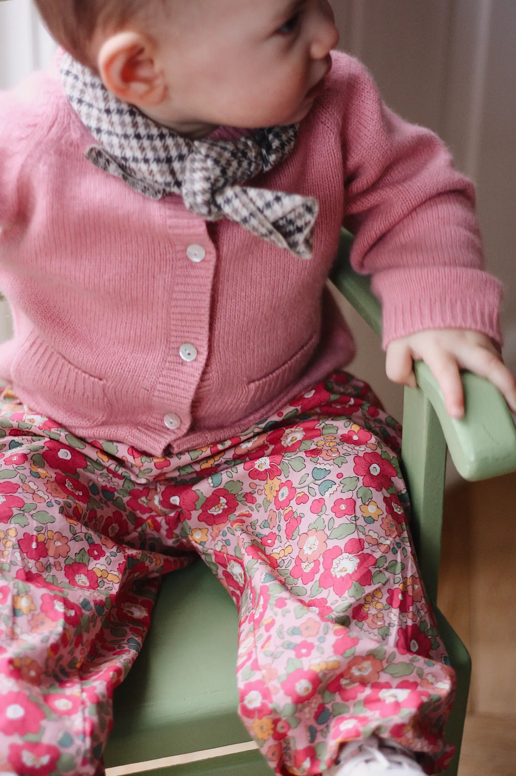 Baby girl wearing Lalaby Pixi baby pants in Berry besty pink liberty organic cotton