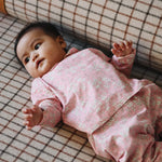 Baby girl wearing Lalaby Pixi pants in pink flower cotton liberty corduroy
