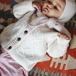 Baby girl wearing Lalaby Pixi pants in pink flower cotton liberty corduroy