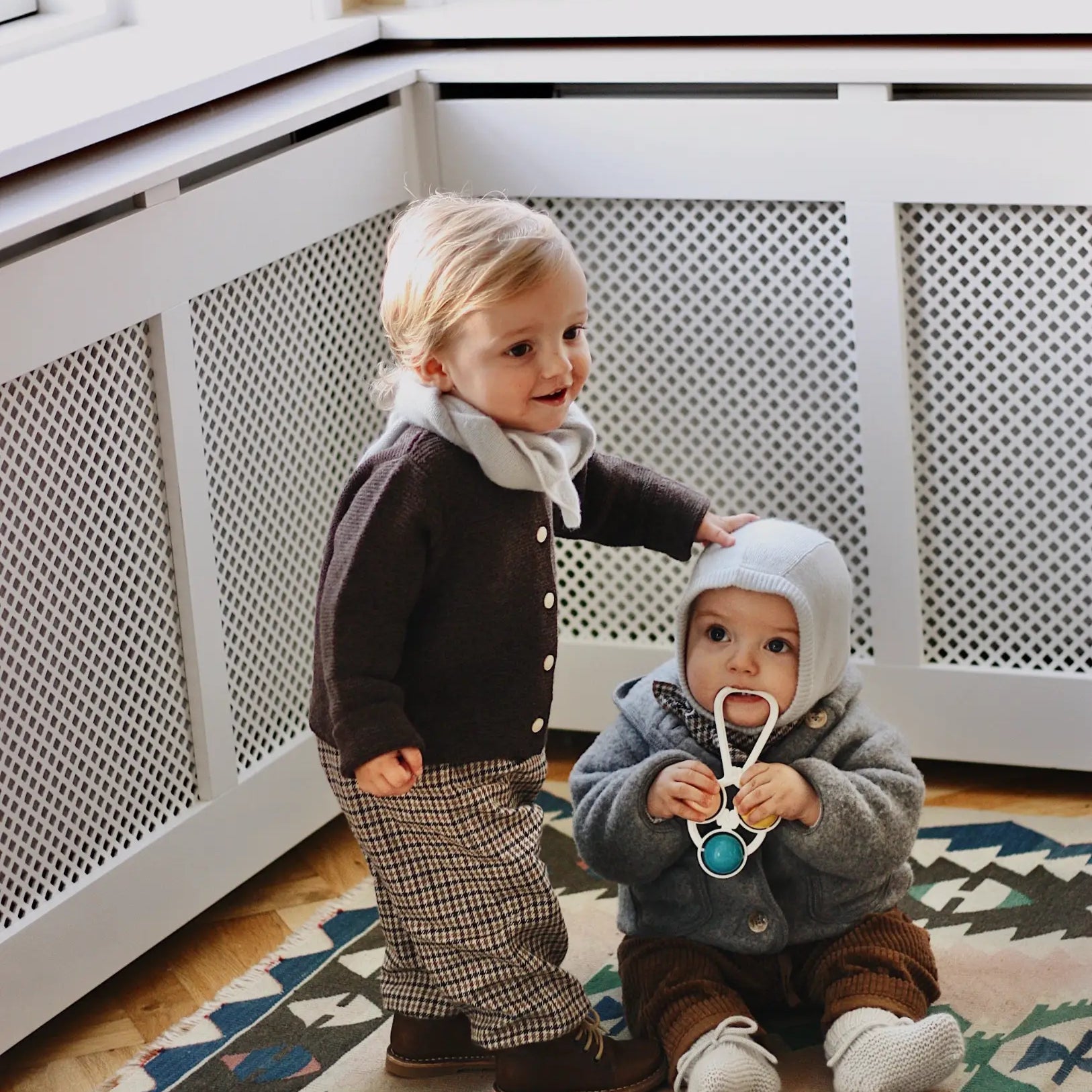 Baby boy wearing Lalaby Pixi pants for babies in tweedy check organic cotton