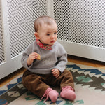 Baby girl wearing Lalaby Sister baby sweater in a grey baby wool, yak and cashmere blend