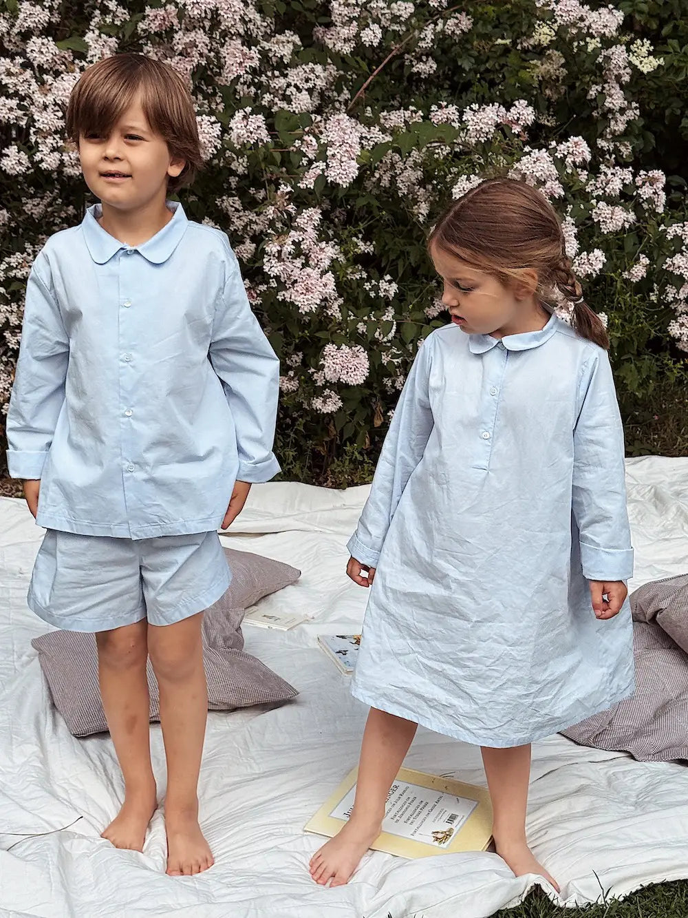 Boy and girl wearing Lalaby summer pyjamas and pj dress for kids in sky blue organic cotton