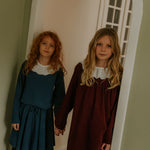 Girl wearing Lalaby Thea kids top in whale blue cotton baby cord