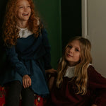 Girl wearing Lalaby Thea kids top in whale blue cotton baby cord