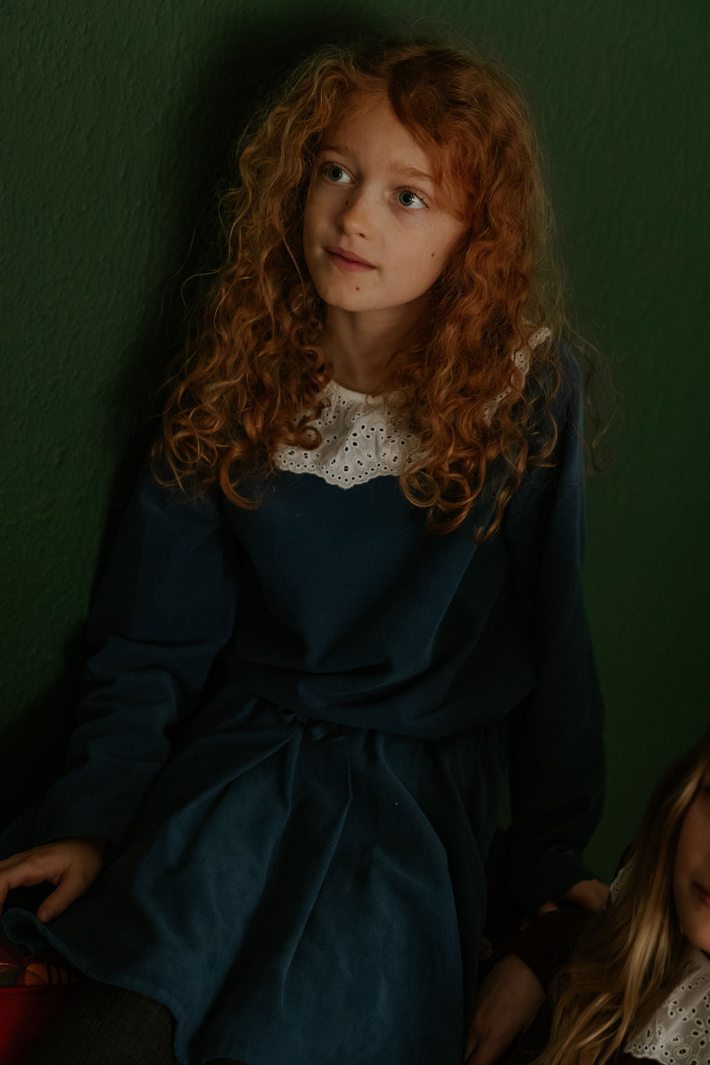 Girl wearing Lalaby Thea kids top in whale blue cotton baby cord