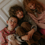Girl wearing Lalaby Vera scarf for kids and adults in tweedy check organic cotton